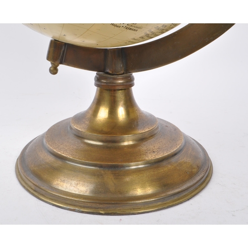 320 - A large vintage 20th century desk top globe. The globe featuring a brass style mounting, raised on a... 