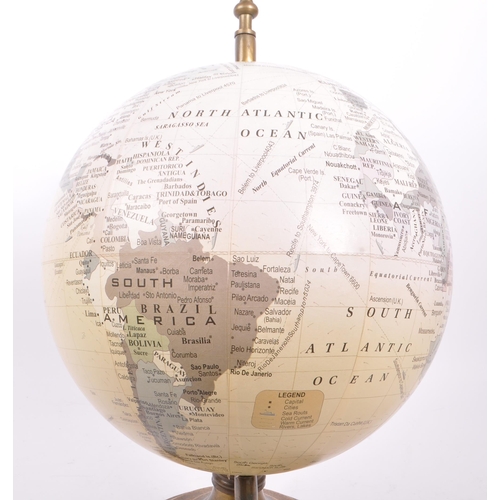 320 - A large vintage 20th century desk top globe. The globe featuring a brass style mounting, raised on a... 