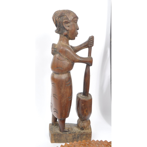 235 - A collection of wooden tribal folk art decorative pieces / curios. The collection to include a carve... 