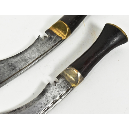 119 - Two vintage Nepalese / Gurkha Kukri knife daggers. Brass capped pommels with smooth wooden grips, br... 