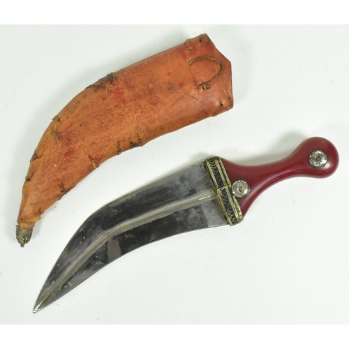 174 - An early 20th Century South Arabian / Yemen Jambiya knife / dagger. Red Bakelite grip with applied c... 