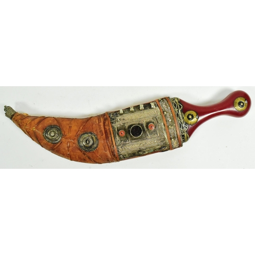 174 - An early 20th Century South Arabian / Yemen Jambiya knife / dagger. Red Bakelite grip with applied c... 