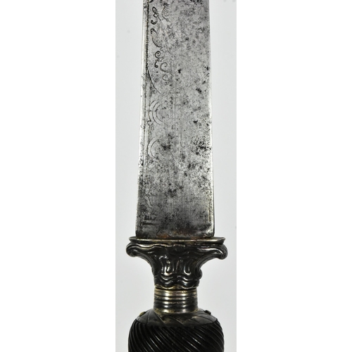 190 - An 18th Century French reversible hilt plug bayonet. Black horn grip carved with sweeping channels u... 