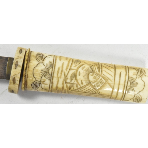 192 - A 20th Century Japanese Tanto knife / dagger with bone scrimshaw handle and scabbard. Extensively ca... 