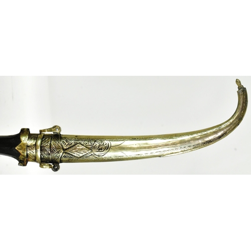 198 - An early 20th Century Moroccan Koummya Jambiya dagger. Dome shaped white metal pommel with a waisted... 