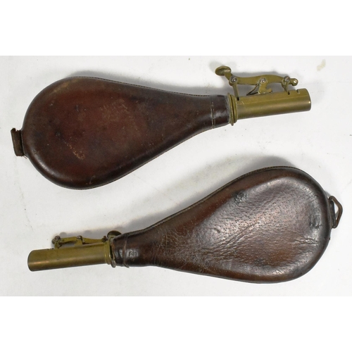 201 - Two early 20th Century Musket powder flasks. Brown leather pouches with brass necks and spring latch... 