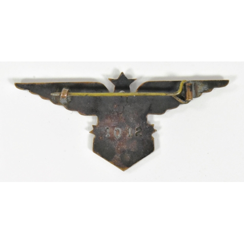 268 - A WWII Second World War Free French Air Force badge. A star between a pair of stylized wings and a c... 