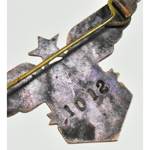 268 - A WWII Second World War Free French Air Force badge. A star between a pair of stylized wings and a c... 