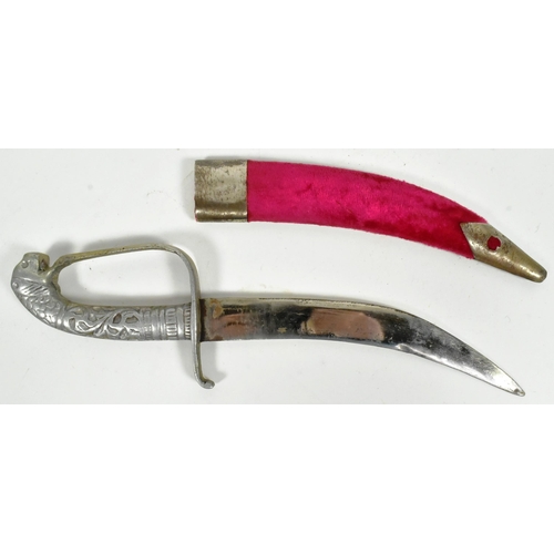 291 - An early 20th Century small Indian parade / dress dagger. White metal hilt in the form of a mythical... 