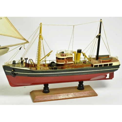 293 - Two vintage hand made scratch built model boats comprising a pond yacht with white sails and a steam... 