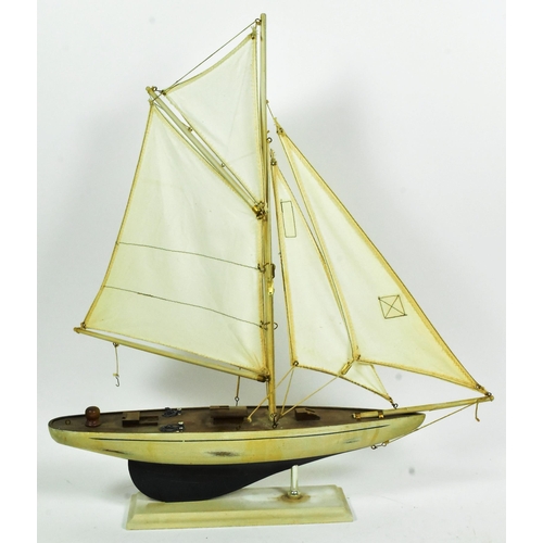 293 - Two vintage hand made scratch built model boats comprising a pond yacht with white sails and a steam... 