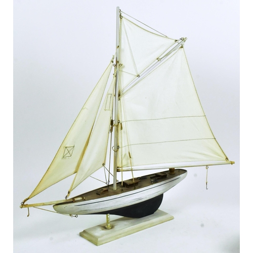 293 - Two vintage hand made scratch built model boats comprising a pond yacht with white sails and a steam... 