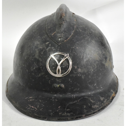 305 - A WWII Second World War French Milice helmet. The black Adrian pattern helmet with a metal ' Gamma '... 