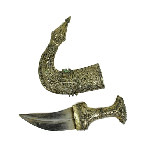 313 - An early 20th Century Middle Eastern / Omani Khanjar / Jambiya dagger. Pressed white metal grip with... 