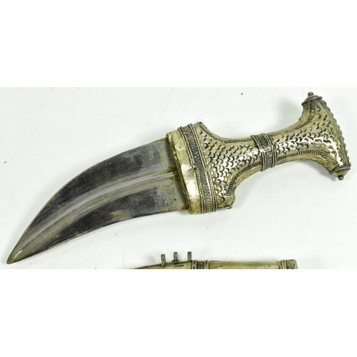 313 - An early 20th Century Middle Eastern / Omani Khanjar / Jambiya dagger. Pressed white metal grip with... 