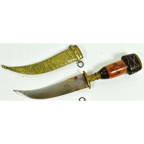 318 - A pair of Syrian Jambiya daggers with brass floral motif pommels, layered man made grips inlaid with... 