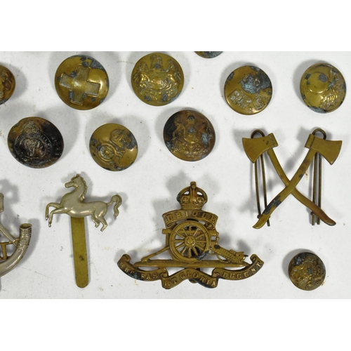 323 - A collection of WWII Second World War and other Military cap badges and uniform buttons to include; ... 