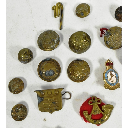 323 - A collection of WWII Second World War and other Military cap badges and uniform buttons to include; ... 