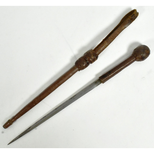 34 - A leather lined cosh weapon with an iron ball pommel covered with plaited leather and a concealed sq... 