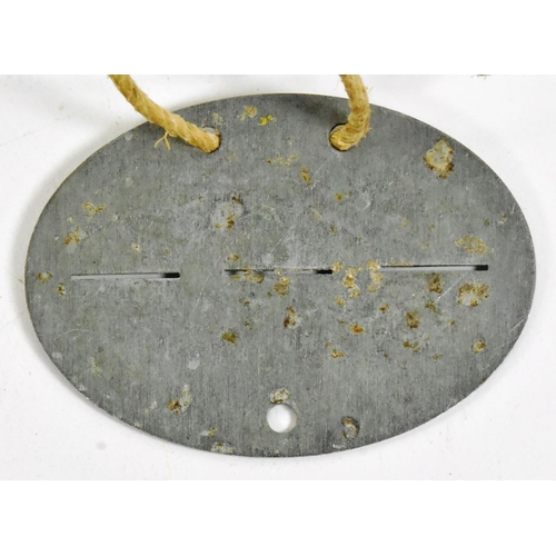 346 - A WWII Second World War Third Reich Nazi German dog tag for an Infantry Driver. Housed in a small ha... 