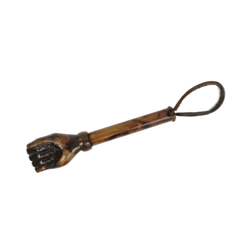 36 - A vintage hardwood truncheon with the pommel carved in the form of a fist. The shaft with a leather ... 