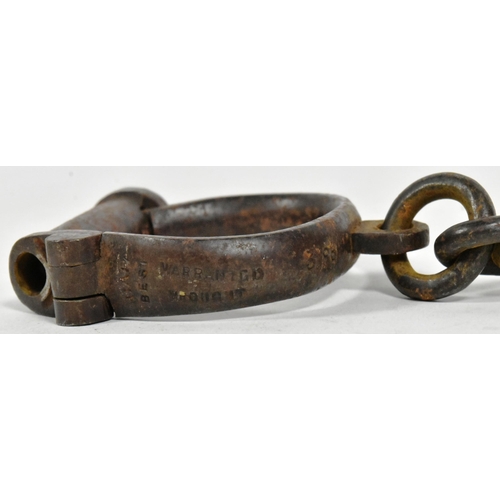 367 - A pair of 19th Century Victorian Police handcuff shackles with key. Stamped Hiatt Best Warranted 388... 