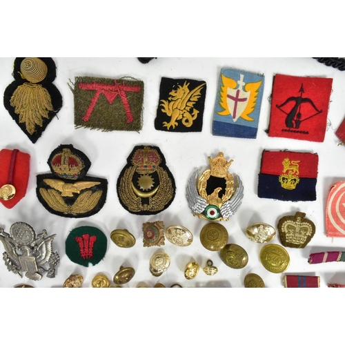 371 - A large collection assorted WWII Second World War and later military cap badges, uniform buttons, me... 