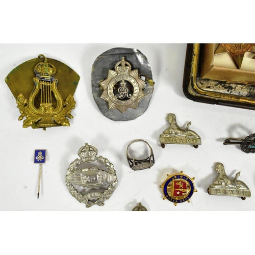 393 - A collection of WWII Second World War British Army cap badges and medals to include; 1939-45 Star, I... 