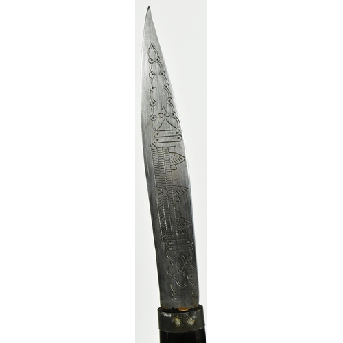 418 - A mid 20th Century South East Asian ( Cambodia ) horn hilted dagger. The elongated grip carved and i... 