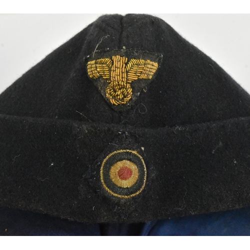 419 - A WWII Second World War Third Reich Nazi German Kriegsmarine side cap. Blue wool construction with f... 