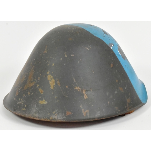 76 - A Cold War era East German M56 steel combat helmet with post war memorial artwork depicting a hand p... 