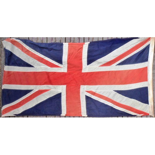 88 - A large British Union Jack linen flag with wooden flag pole and hoist. Flag measures approx 67x125cm... 