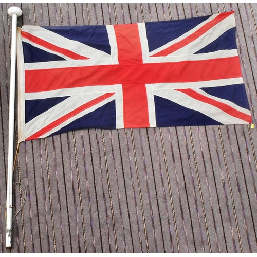 88 - A large British Union Jack linen flag with wooden flag pole and hoist. Flag measures approx 67x125cm... 