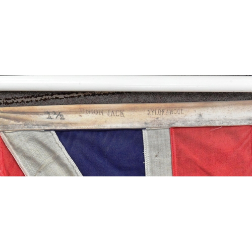 88 - A large British Union Jack linen flag with wooden flag pole and hoist. Flag measures approx 67x125cm... 