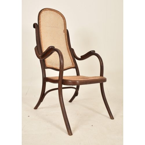 125 - Thonet, Germany - An early 20th century bentwood & cane fireside high back armchair. The chair havin... 