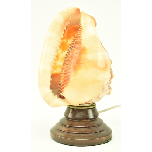 137 - An early / mid 20th century cameo carved conch shell desk table lamp. The lamp having a conch shell ... 