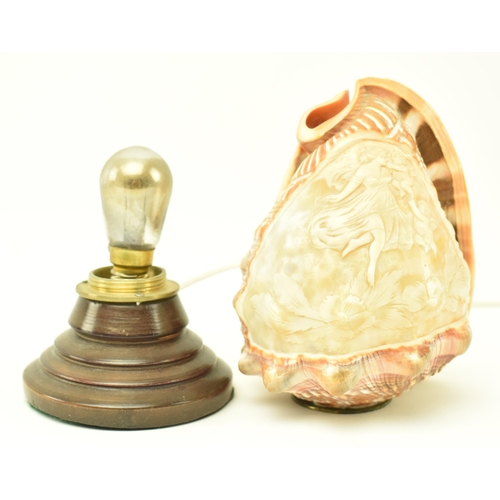 137 - An early / mid 20th century cameo carved conch shell desk table lamp. The lamp having a conch shell ... 