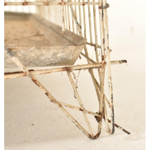 141 - A vintage mid century white painted wire-work birdcage. The bird cage floor standing, featuring two ... 