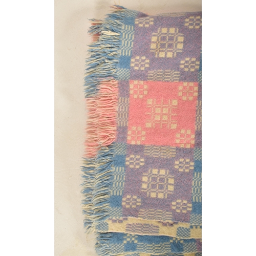 144 - A 20th century hand made woollen traditional Welsh blanket. The blanket throw in pink, Blue and purp... 