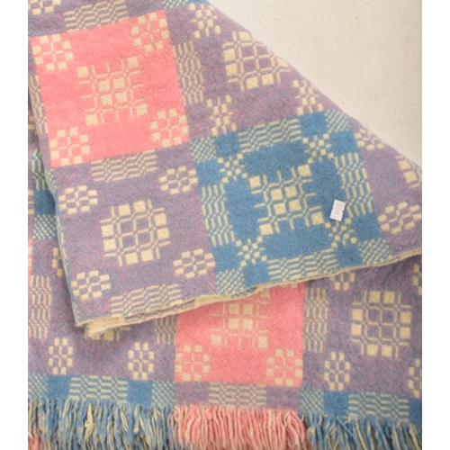 144 - A 20th century hand made woollen traditional Welsh blanket. The blanket throw in pink, Blue and purp... 