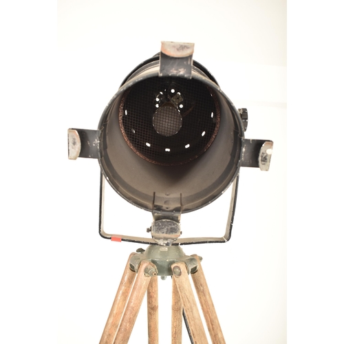 168 - A vintage mid 20th century theatre / cinema spot lamp light. The lamp raised on a military issue oak... 