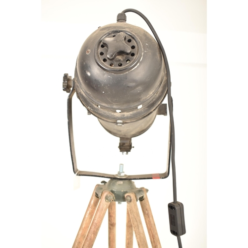 168 - A vintage mid 20th century theatre / cinema spot lamp light. The lamp raised on a military issue oak... 