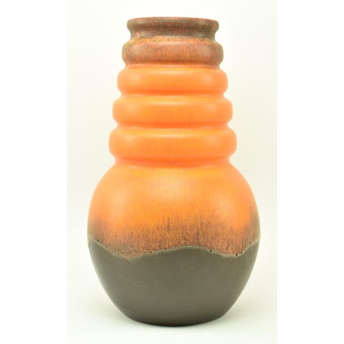 179 - A vintage mid 20th century West German pottery vase. The vase ribbed, featuring four collars over bu... 