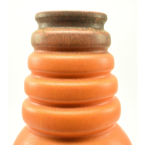 179 - A vintage mid 20th century West German pottery vase. The vase ribbed, featuring four collars over bu... 