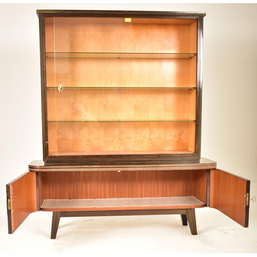 199 - A retro mid 20th century German designer cabinet on stand / display case. The cabinet having formica... 