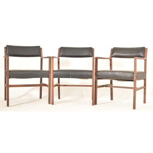 203 - Alfred Cox - A set of six 1970s teak wood dining chairs / office chairs. The chairs having curved ar... 