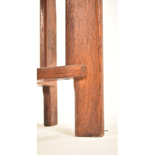 223 - A vintage 20th century Art Deco oak stool. The stool having a circular padded leather upholstered to... 