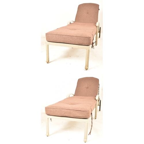 617 - A pair of late 20th century metal framed sun loungers. Each of typical form having an adjustable bac... 