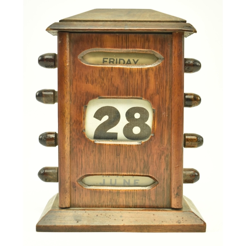 62 - An Art Deco early 20th century oak cased English perpetual desk table calendar. The calendar having ... 