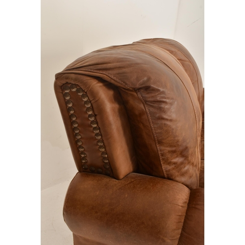 65 - British Modern Design - A retro 20th century brown leather two seater sofa settee. The sofa having a... 